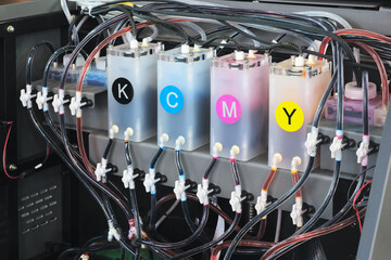 A close up of a printer with the colors KCMY printed on it