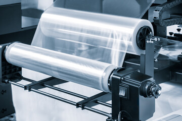 Automatic polyethylene plastic bag production machine with lighting effect. Close-up of the roller...