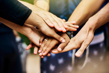 Teamwork, stack hands and people outdoor for celebration, success or motivation. Group, friends and huddle together closeup for solidarity of community with trust, connection and support for goal