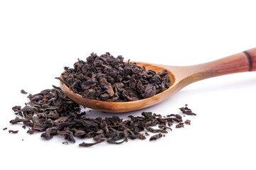 A wooden spoon filled with black tea leaves