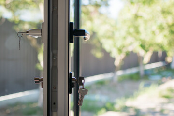 A fragment of a new plastic door with a handle in a private house
