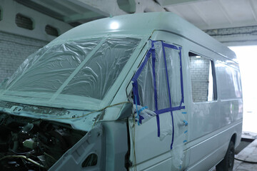 painting a van white in a paint shop © velimir