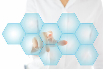 Person touching an hexagonal button on a digital interface