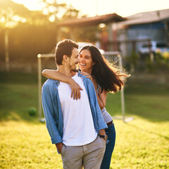 Date, funny and happy couple outdoor for love, care and bonding together at park. Laughing, man and woman embrace at garden for support, talking and joke for relationship on vacation at soccer field © JorSons/peopleimages.com