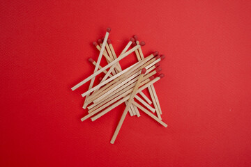 Box with new matchsticks on color background. Scattered wooden matches without a box close-up. Design

