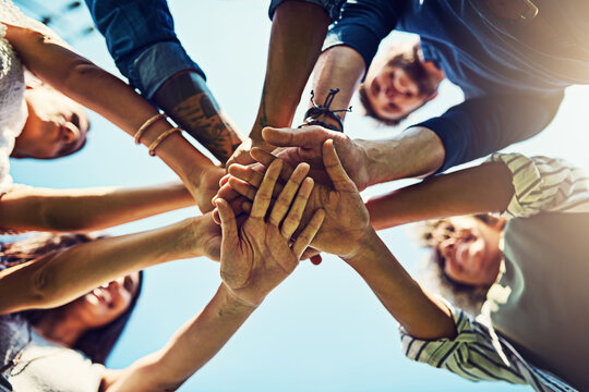 Hands, low angle and pile for team building with friends outdoor, support and solidarity in nature. Community, mission and partnership, trust and commitment with loyalty, group huddle and agreement