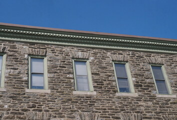 Colonial Stone Exterior Wall with Window Trim in Light Green, Sky