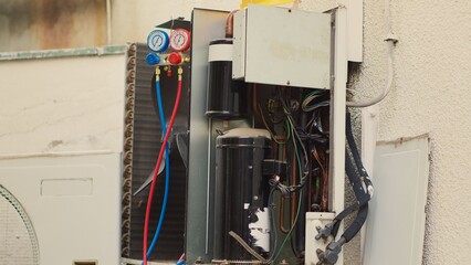 Close up zoom in shot of manifold meters inside opened faulty air conditoner. Set of barometer...