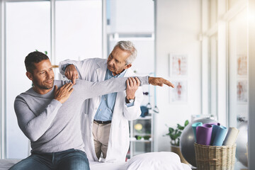 Doctor, man and patient with stretching for shoulder pain with physical therapy, healthcare or body...