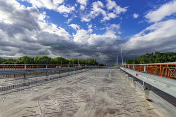 Fototapeta premium A bridge with a cloudy sky in the background