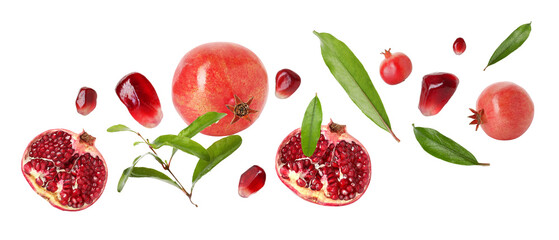 Fresh pomegranates, seeds and leaves in air on white background