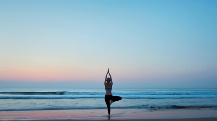 Woman practicing yoga on the beach during sunrise, achieving balance and tranquility with the serene ocean backdrop.