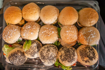 A dish of bread rolls filled with tasty fillings at a party