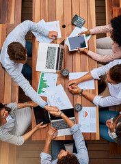 Strategy, planning and business people shaking hands at workshop with data analysis, stats and tech...