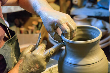 Europe, Romania. Baia Sprie. Pottery, potter's shop. Throwing clay to make pots.