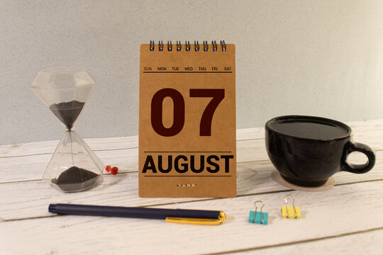Cube shape calendar for August 07 on wooden surface with empty space for text