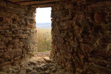Fototapeta premium Europe, Romania. Viscri. View from stone window in Fortified Church.