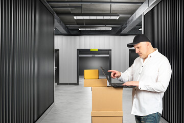 Self storage unit. Man in building with personal warehouses. Open storage unit behind person. Man...