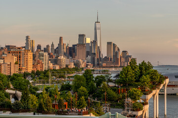 Downtown New York City and Little Island Park as seen from Pier 57 at sunset.
