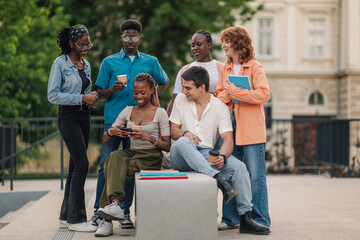 Diverse college students having coffee break at university campus.