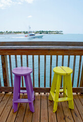 Colorful Painted Wooden Stools on Sunset Pier in Key West Florida USA