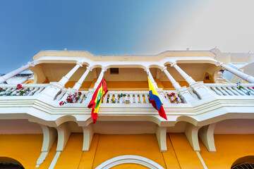 Balcony with flags on the facade of the Getsemani Shopping Center in Cartagena de Indias, Colombia