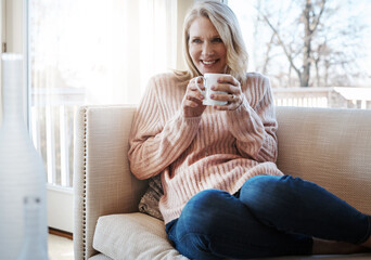 Senior woman, relax and matcha in living room for peace, resting and hot beverage for drinking on weekend. Female person, espresso and proud for retirement in home, wellness and tea for comfort