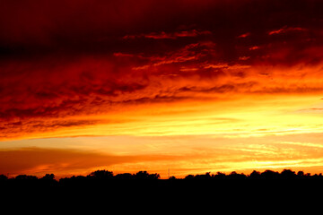 Red and orange winter sunset in the country