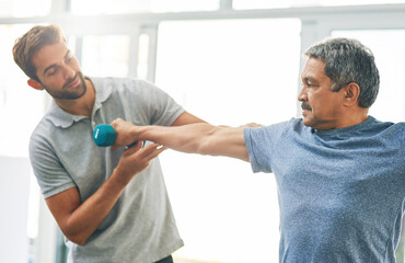 Senior man, fitness and dumbbell with physiotherapist for rehabilitation, wellness and muscle exercise. Elderly person, workout and hand weight for management of pain, arthritis and anatomy health