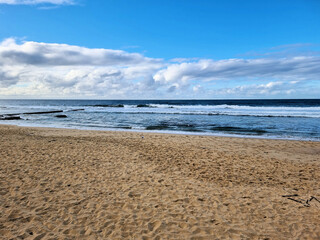 Deserted Bar Beach Newcastle New South Wales. On a Cold Winter's Day. Sandy Beach With Blue Sky Clouds and Surf