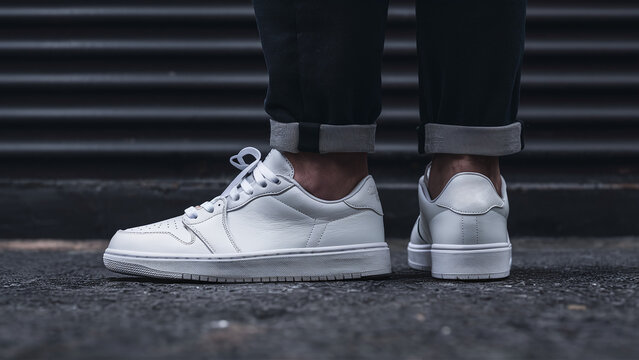 blank white sneakers on black background, professional product photography