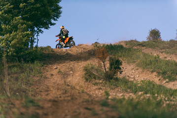 Obraz premium Professional enduro bike rider dirt ride on the muddy road. Motocross sport. 