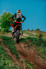 Professional enduro bike rider dirt ride on the muddy road. Motocross sport. 