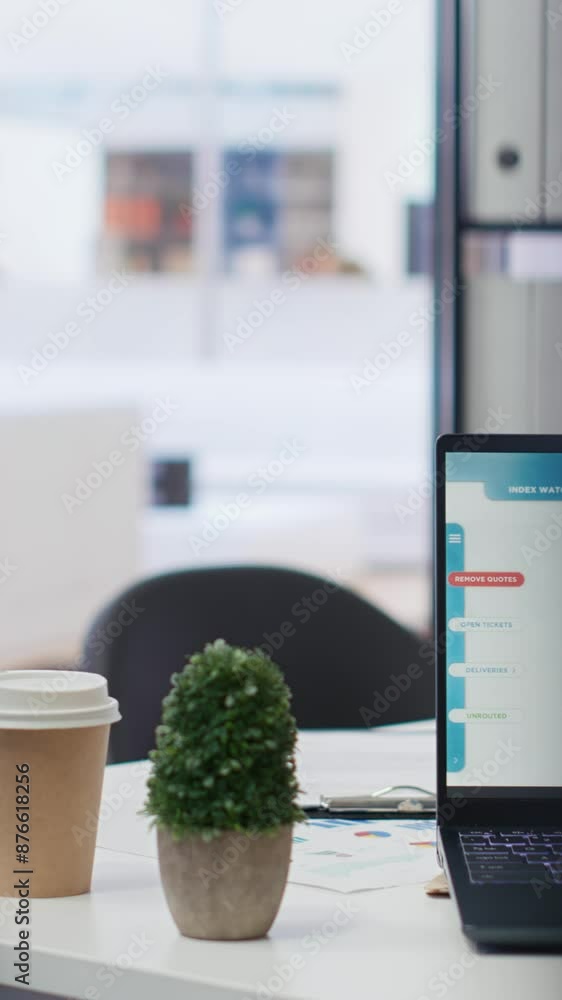 Poster vertical video laptop device on corporate office desk in empty workspace showing volatile stock exch