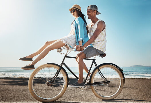 Travel, ocean and happy couple on bicycle on holiday, vacation and summer weekend for bonding together. Beach, dating and man and woman cycling on bike for journey, relax and fun adventure in Miami - Powered by Adobe