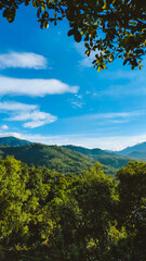 Green hilly landscape with blue sky