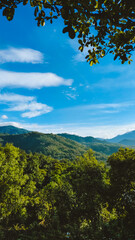 Green hilly landscape with blue sky