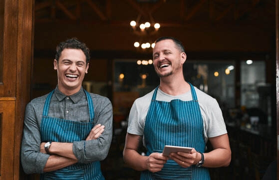 Team, restaurant and men with tablet or online, professional and people for small business startup. Laughing, portrait and pride for success in career in hospitality service, growth and together.