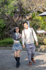 In March, a Taiwanese woman in her twenties and a Hong Kong man are walking in a park near Zhongshan Memorial Hall in Zhongzheng District, Taipei City, Taiwan.