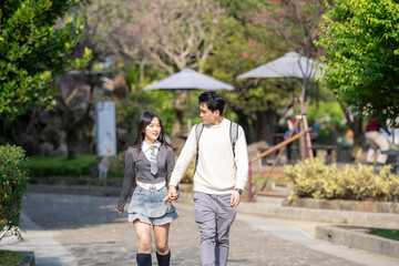 In March, a Taiwanese woman in her twenties and a Hong Kong man are walking in a park near Zhongshan Memorial Hall in Zhongzheng District, Taipei City, Taiwan.