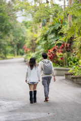 Fototapeta premium In March, a Taiwanese woman in her twenties and a Hong Kong man are walking in a lush botanical garden in Zhongzheng District, Taipei City, Taiwan.