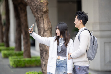 A young Taiwanese woman and a young Hong Kong man walking together on a public road near Zhongshan Memorial Hall station in Zhongzheng District, Taipei City, in March.