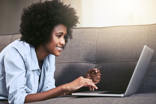 Black woman, happy and credit card on sofa in house for ecommerce, relax and online shopping. Female person, laptop and digital payment for internet subscription, membership or store discount