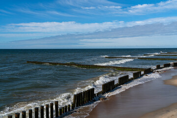Fototapeta premium View of the Baltic Sea and wooden breakwaters of the city beach on a summer day, Svetlogorsk, Kaliningrad region, Russia