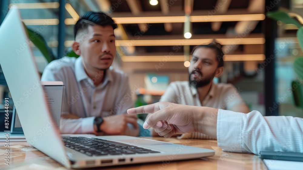 Poster two men are sitting at a table with a laptop in front of them