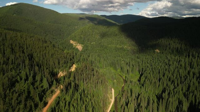 Aerial of dirt roads and creek in Saint Joe Mountains in northern Idaho at sunset