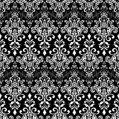Floral pattern. Vintage wallpaper in the Baroque style. Seamless vector background. White and black ornament for fabric, wallpaper, packaging. Ornate Damask flower ornament.