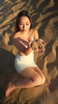 Woman Letting Sand Run Through Fingers