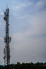 High communication antenna with floating clouds background behind it as advertising space.