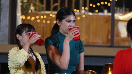 Family gather for holiday celebration. All family member drink beverage in glass to celebrate....